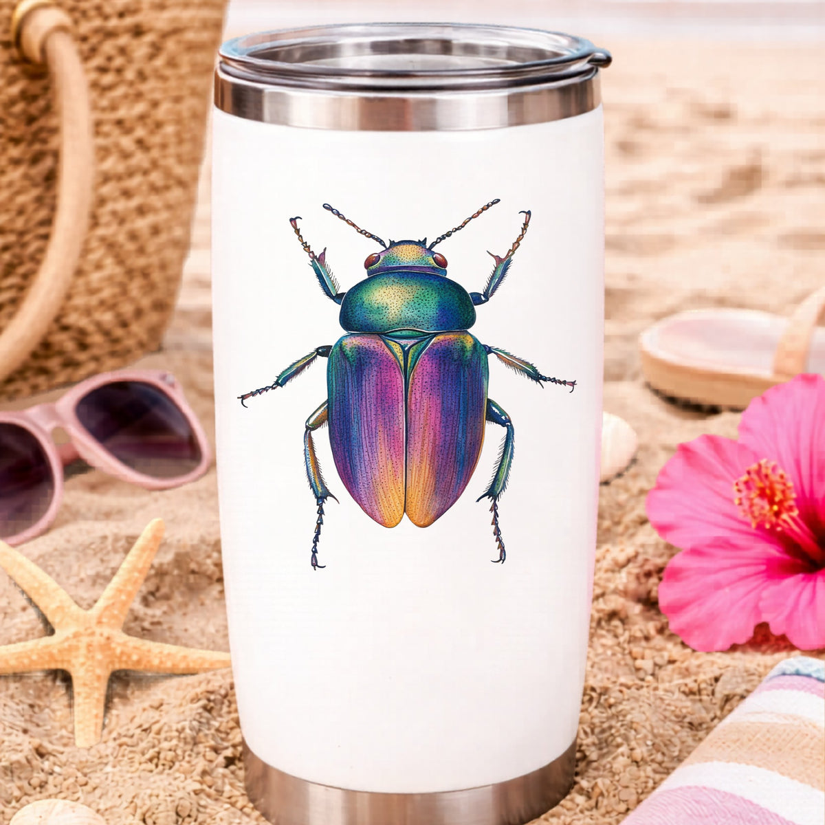Rainbow Iridescent Beetle UV DTF sticker applied to a white travel tumbler on beach sand