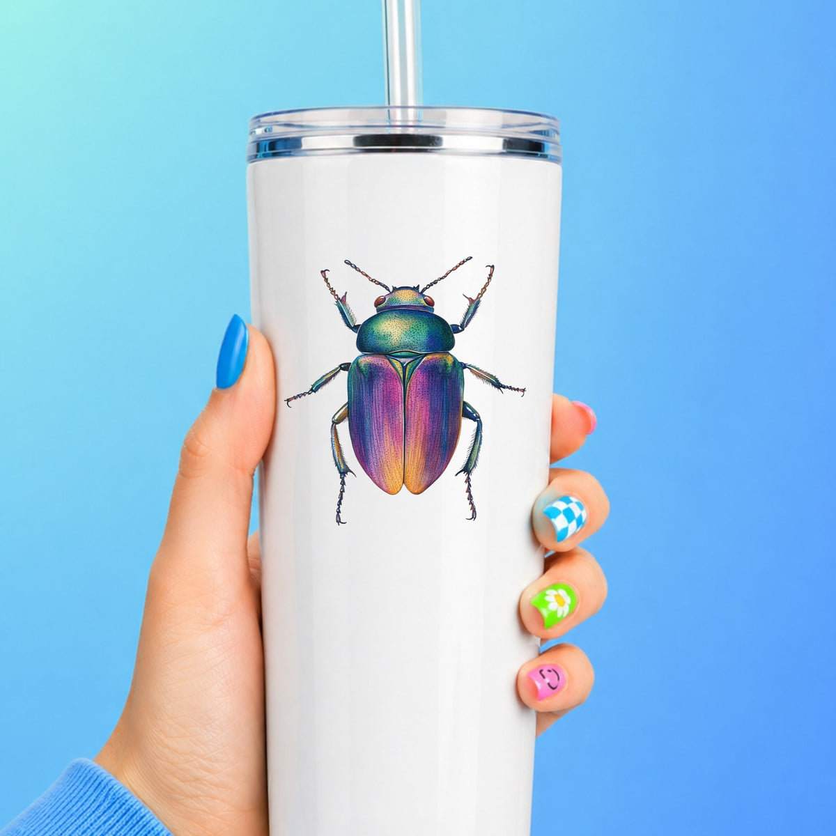 Rainbow Iridescent Beetle UV DTF sticker applied to a white straw tumbler on a blue background