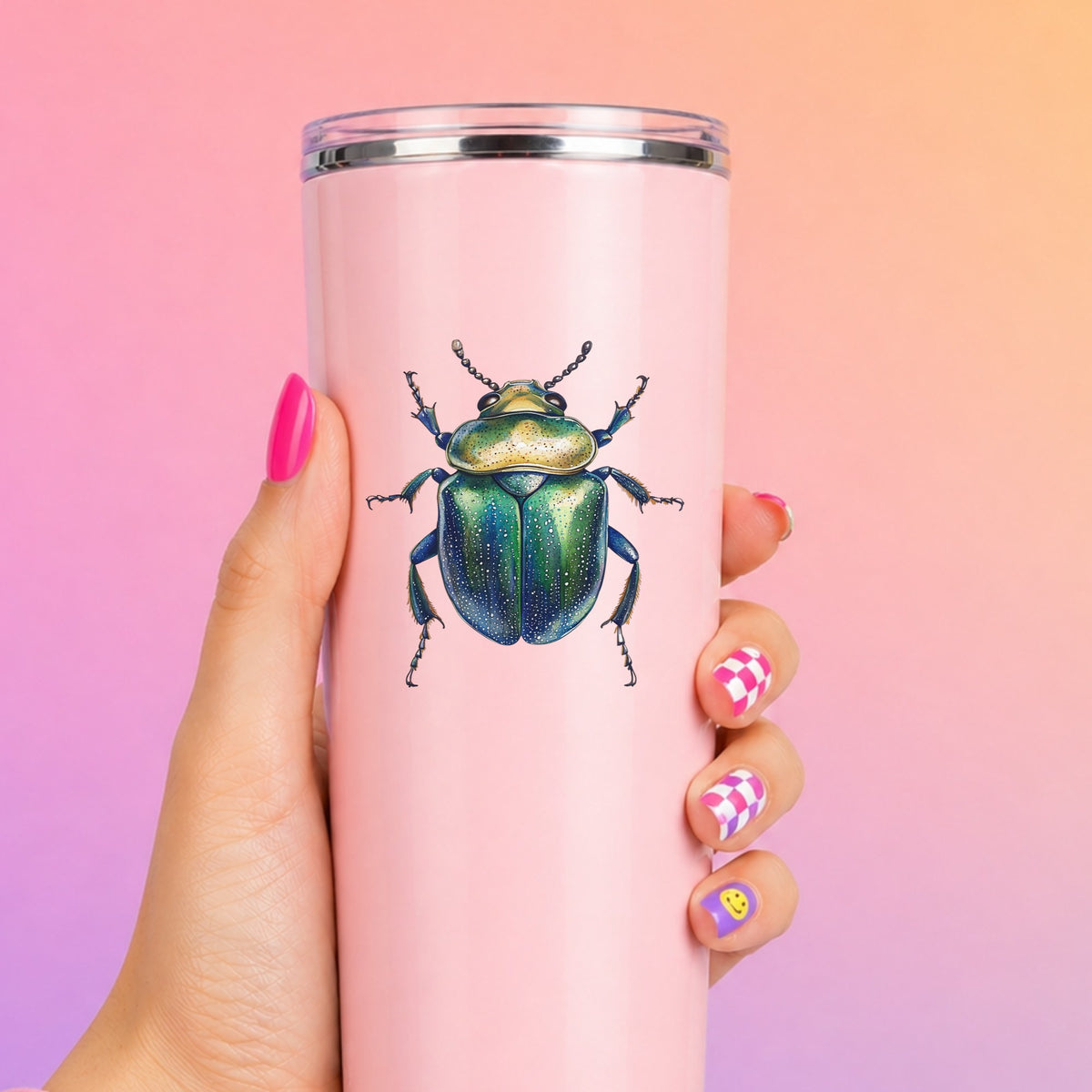 Speckled Green Beetle UV DTF sticker applied to a tall pink tumbler on a pink and orange background