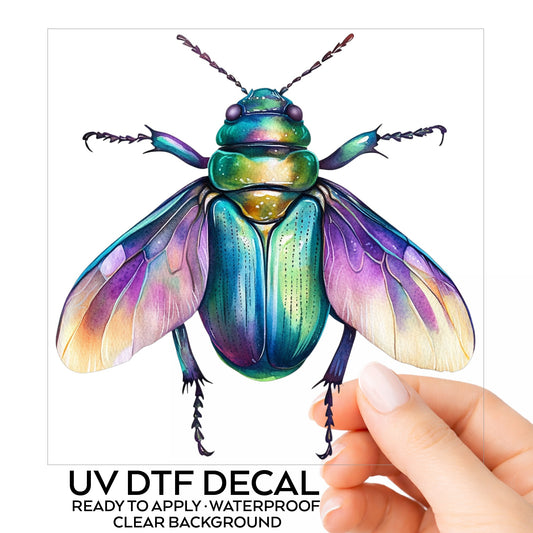 Flying Beetle With Open Wings UV DTF sticker on its backing card, held in hand