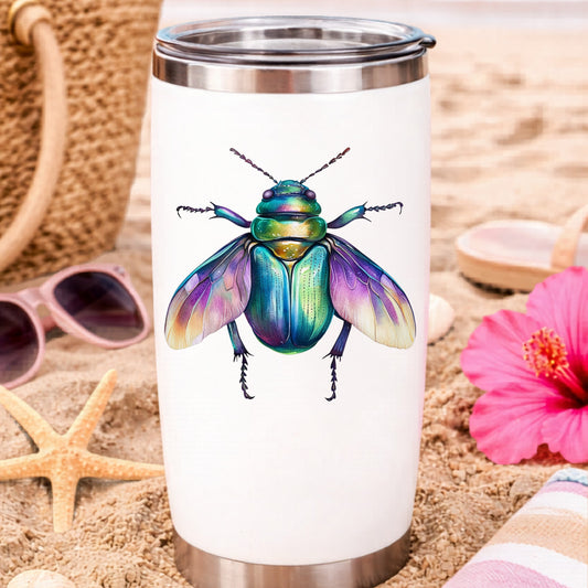 Flying Beetle With Open Wings UV DTF sticker applied to a white travel tumbler on beach sand