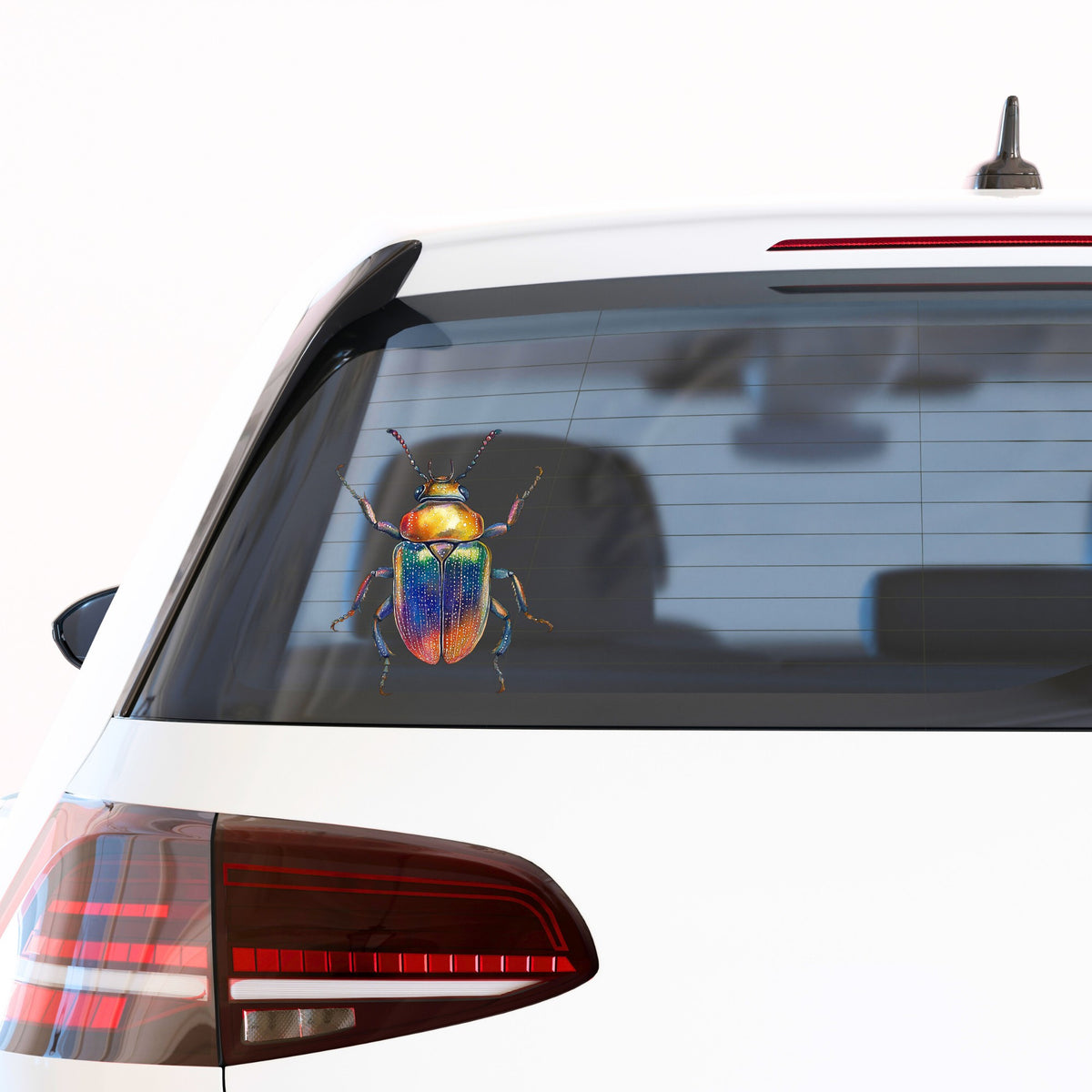 Horned Rainbow Beetle UV DTF sticker applied to the rear window of a white car
