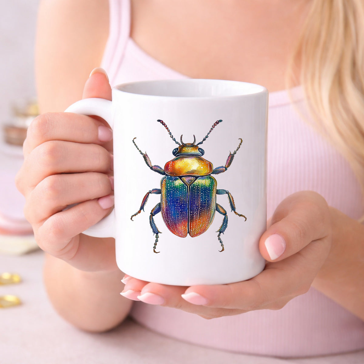 Horned Rainbow Beetle UV DTF sticker applied to a white coffee mug held in both hands