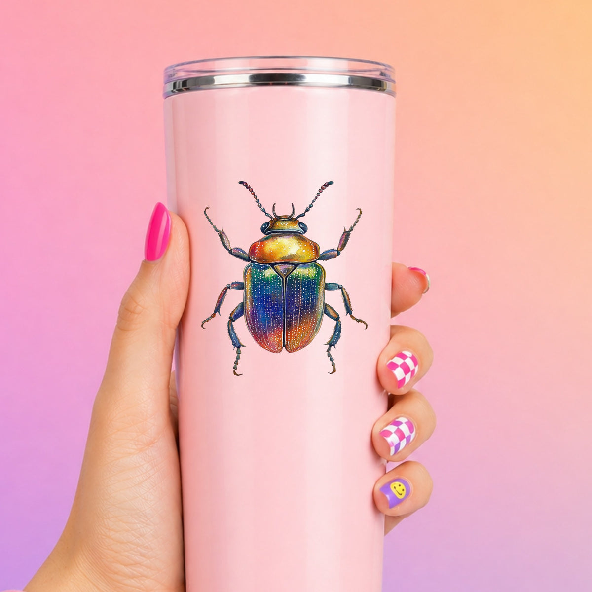 Horned Rainbow Beetle UV DTF sticker applied to a tall pink tumbler on a pink and orange background