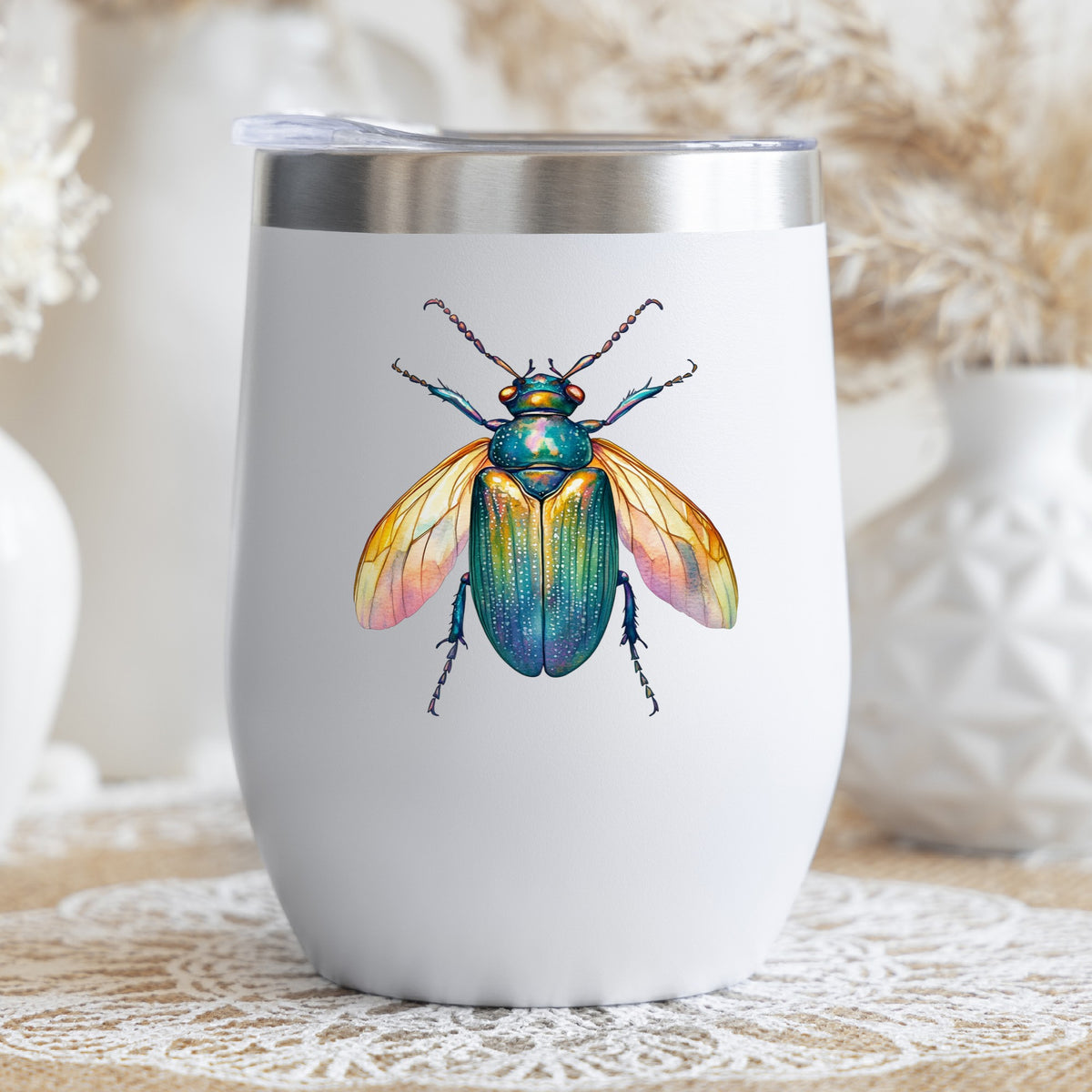 Golden Winged Flying Beetle UV DTF sticker applied to a white stemless tumbler with a lid