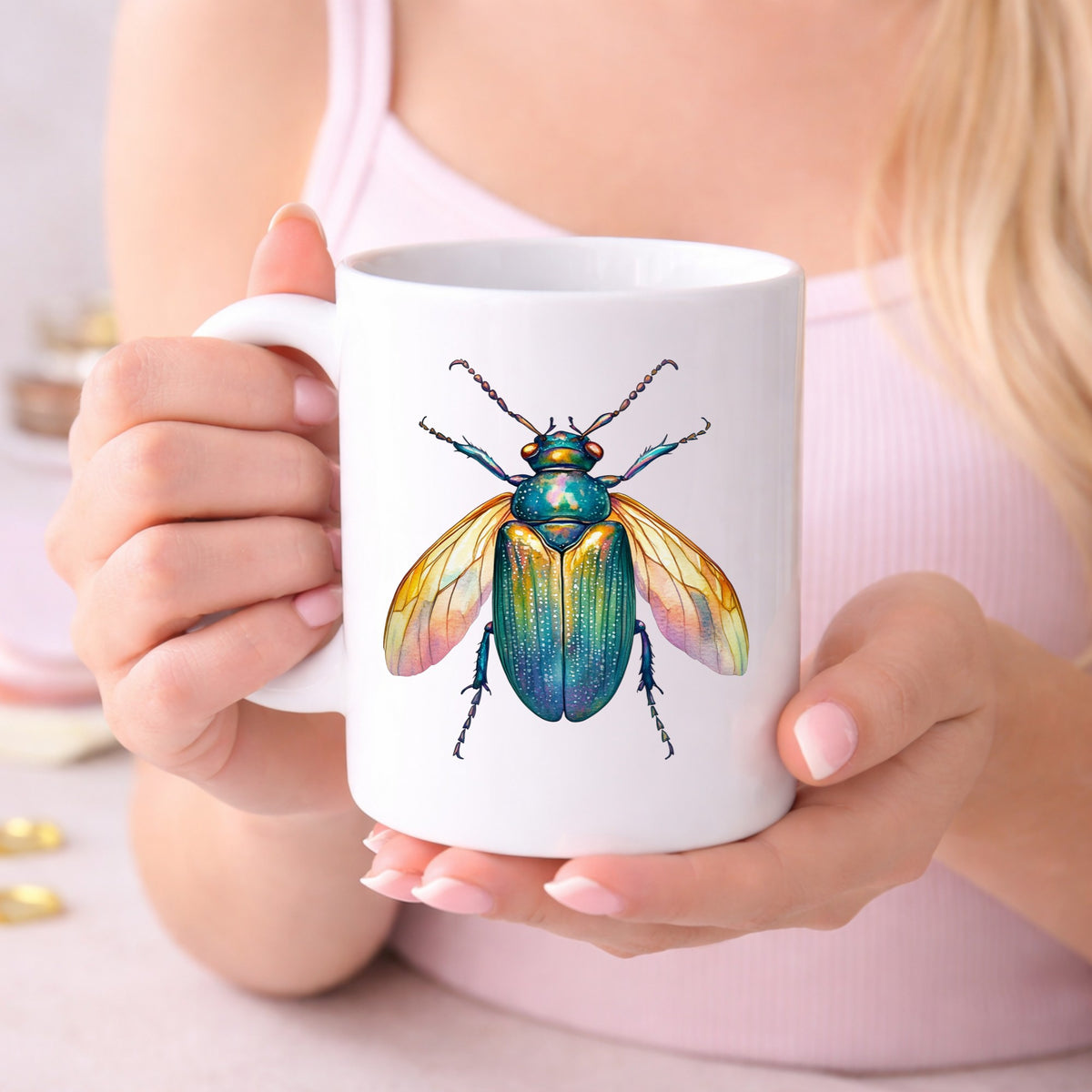 Golden Winged Flying Beetle UV DTF sticker applied to a white coffee mug held in both hands