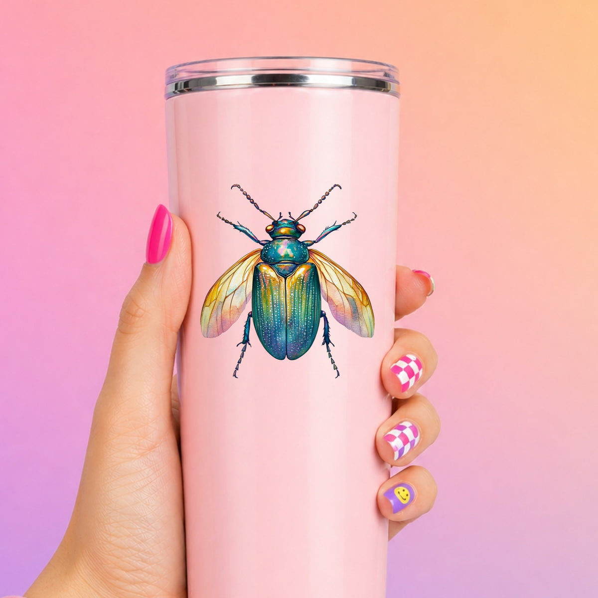 Golden Winged Flying Beetle UV DTF sticker applied to a tall pink tumbler on a pink and orange background