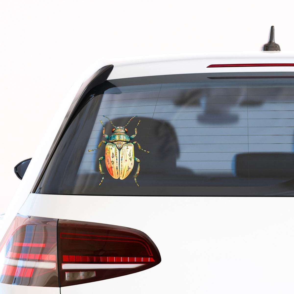 Cream And Coral Jeweled Beetle UV DTF sticker applied to the rear window of a white car