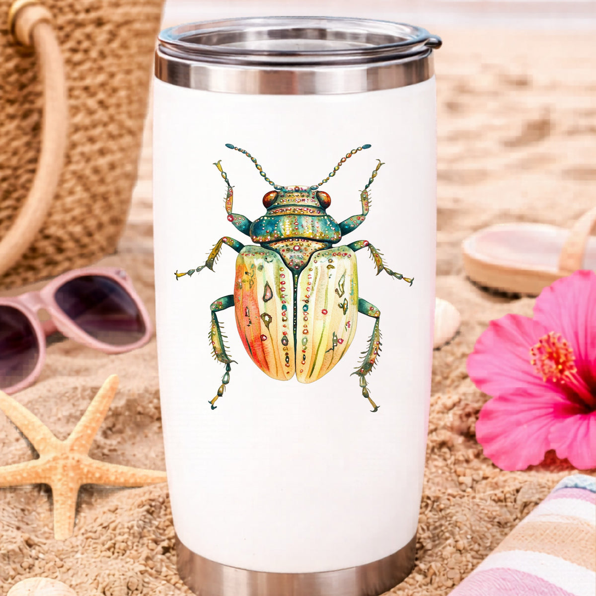 Cream And Coral Jeweled Beetle UV DTF sticker applied to a white travel tumbler on beach sand