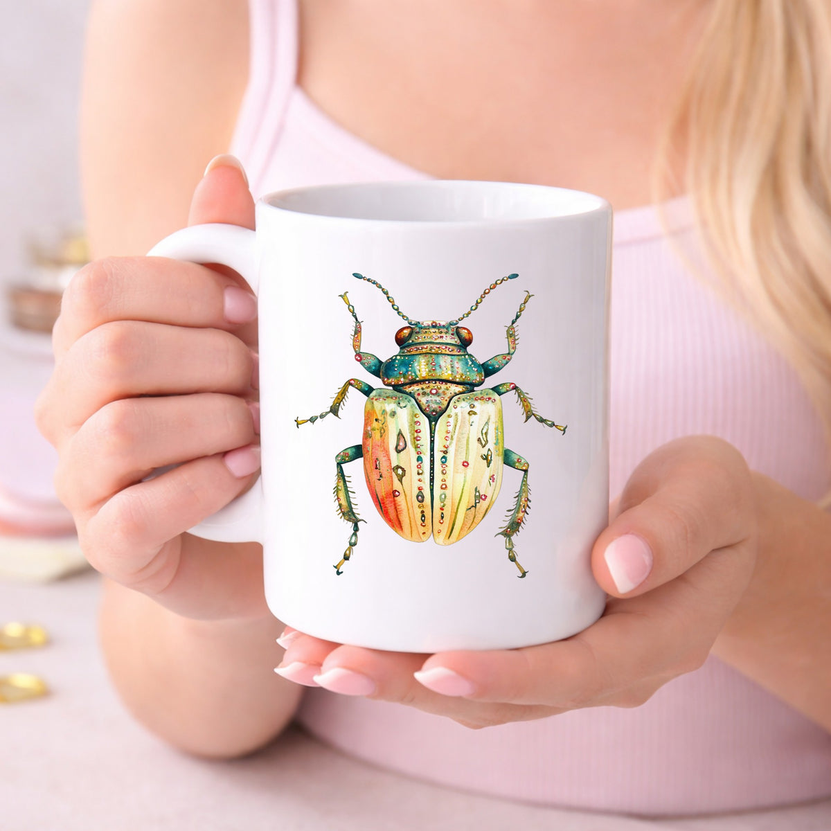 Cream And Coral Jeweled Beetle UV DTF sticker applied to a white coffee mug held in both hands