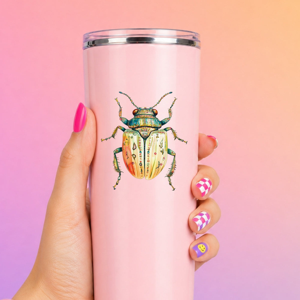 Cream And Coral Jeweled Beetle UV DTF sticker applied to a tall pink tumbler on a pink and orange background