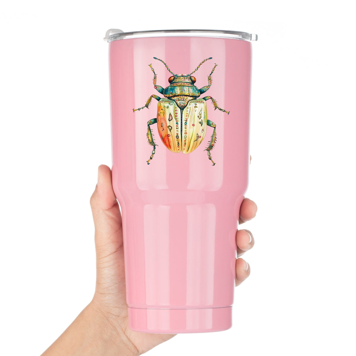 Cream And Coral Jeweled Beetle UV DTF sticker applied to a pink tumbler held against a white background