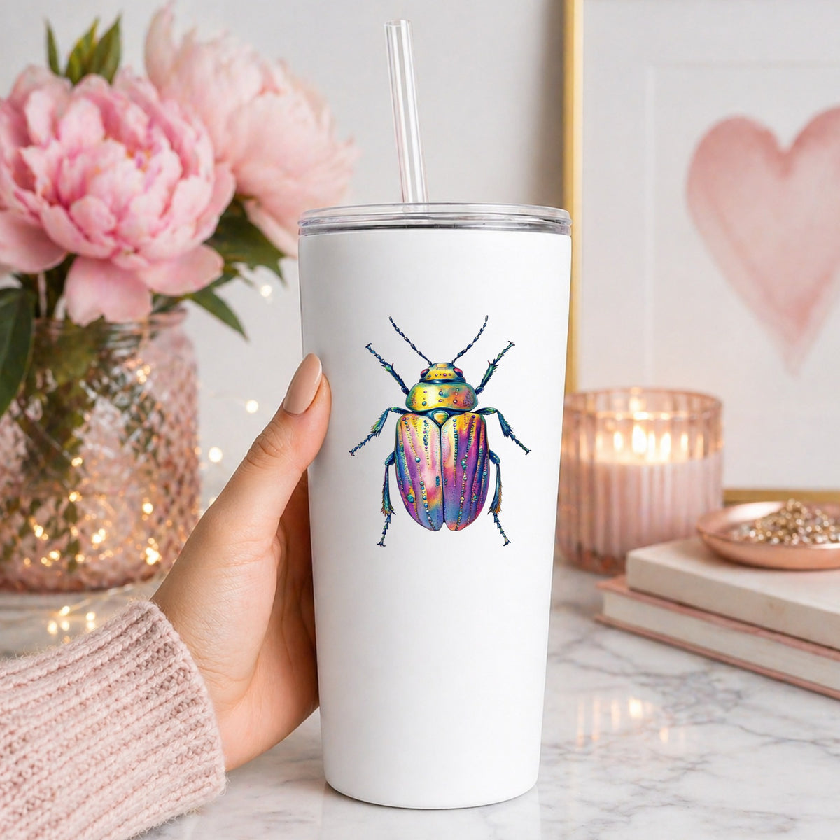 Purple Dewdrop Beetle UV DTF sticker applied to a white straw tumbler beside pink peonies