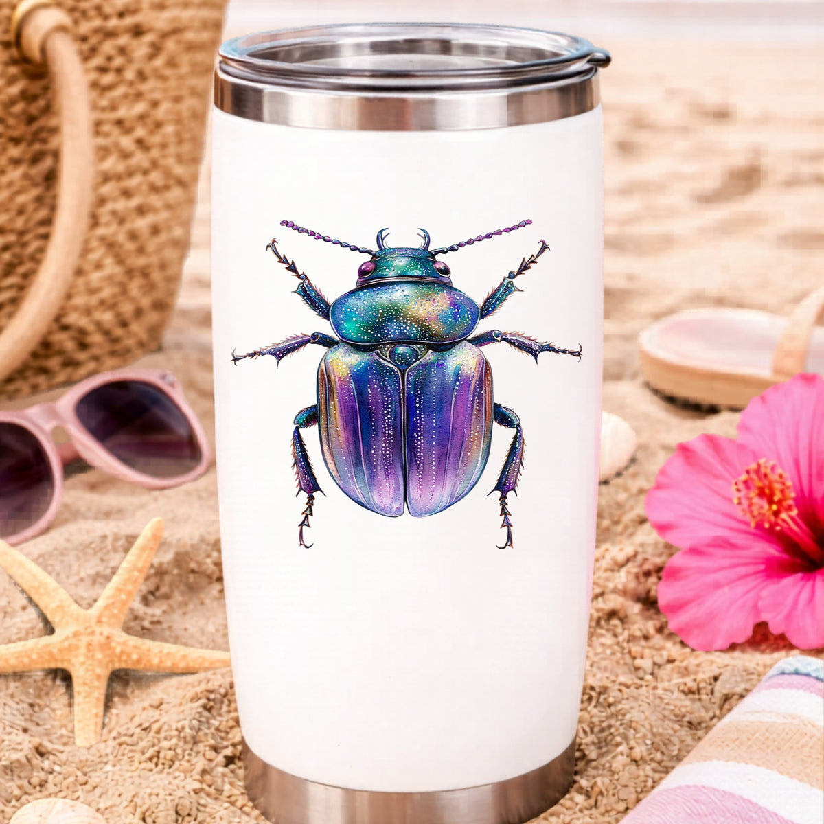 Violet Sparkle Beetle UV DTF sticker applied to a white travel tumbler on beach sand