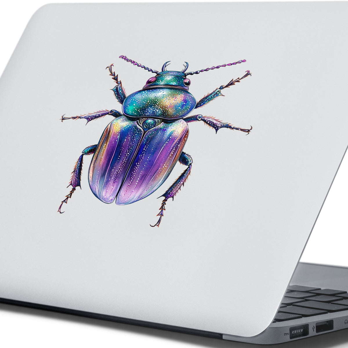 Violet Sparkle Beetle UV DTF sticker applied to the lid of a silver laptop