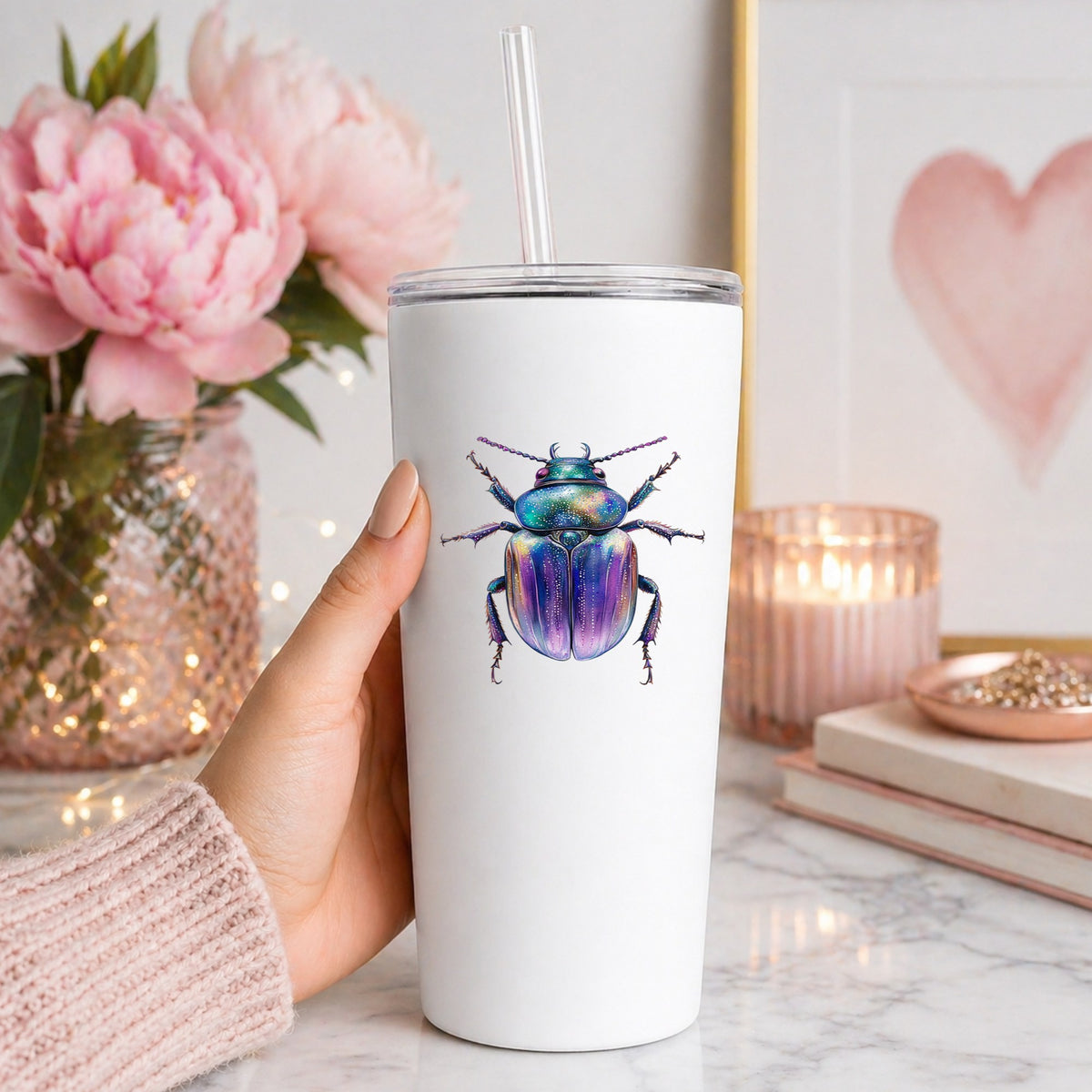 Violet Sparkle Beetle UV DTF sticker applied to a white straw tumbler beside pink peonies