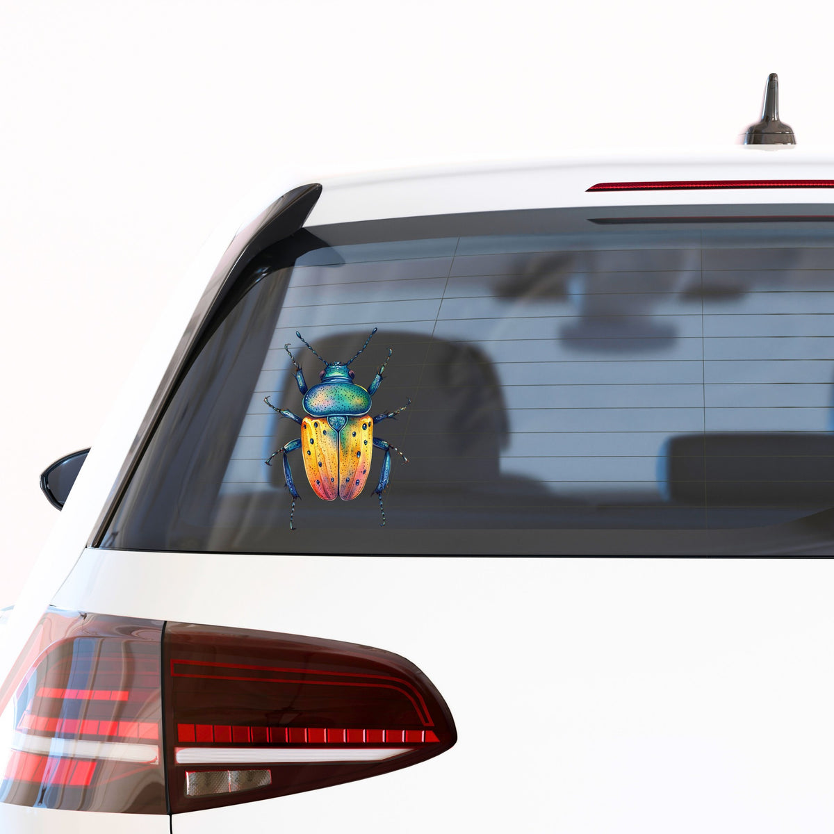 Orange And Blue Spotted Beetle UV DTF sticker applied to the rear window of a white car