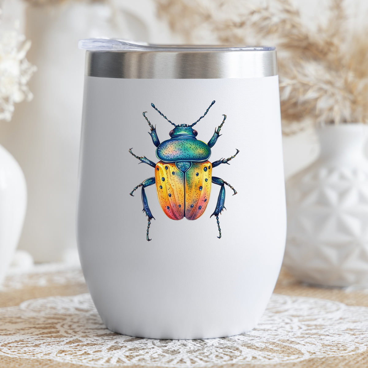 Orange And Blue Spotted Beetle UV DTF sticker applied to a white stemless tumbler with a lid