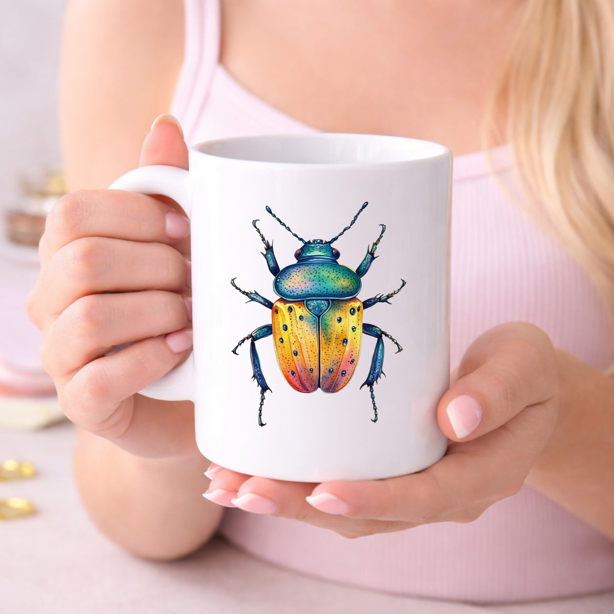 Orange And Blue Spotted Beetle UV DTF sticker applied to a white coffee mug held in both hands