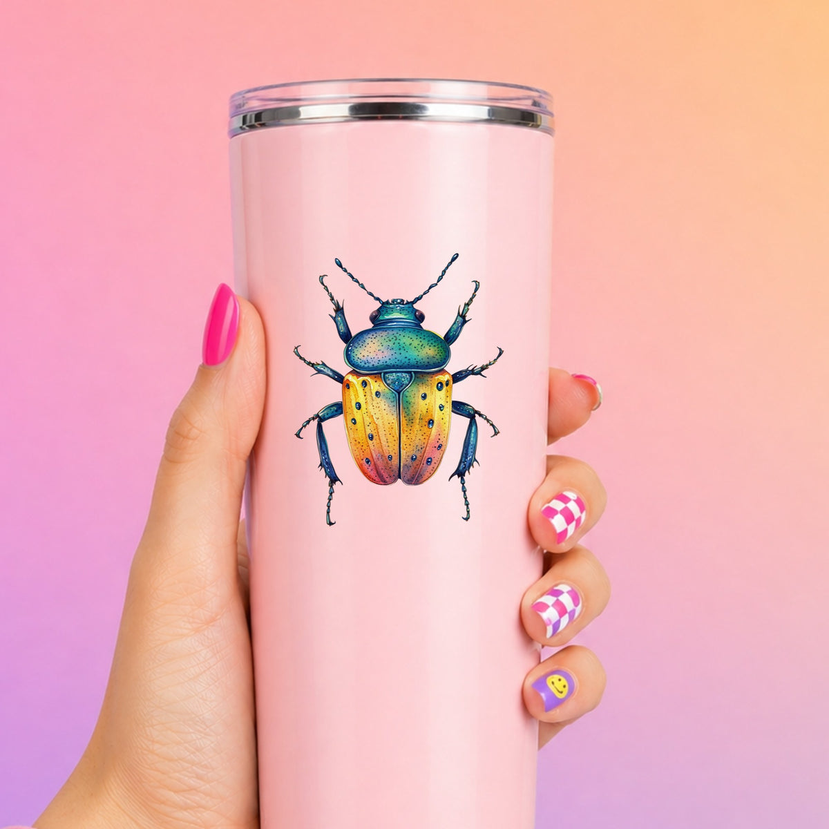 Orange And Blue Spotted Beetle UV DTF sticker applied to a tall pink tumbler on a pink and orange background