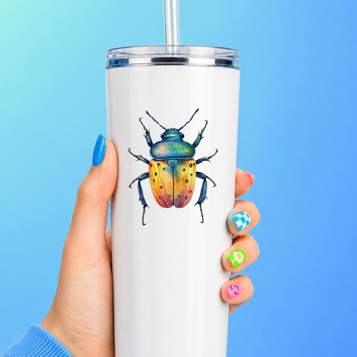 Orange And Blue Spotted Beetle UV DTF sticker applied to a white straw tumbler on a blue background
