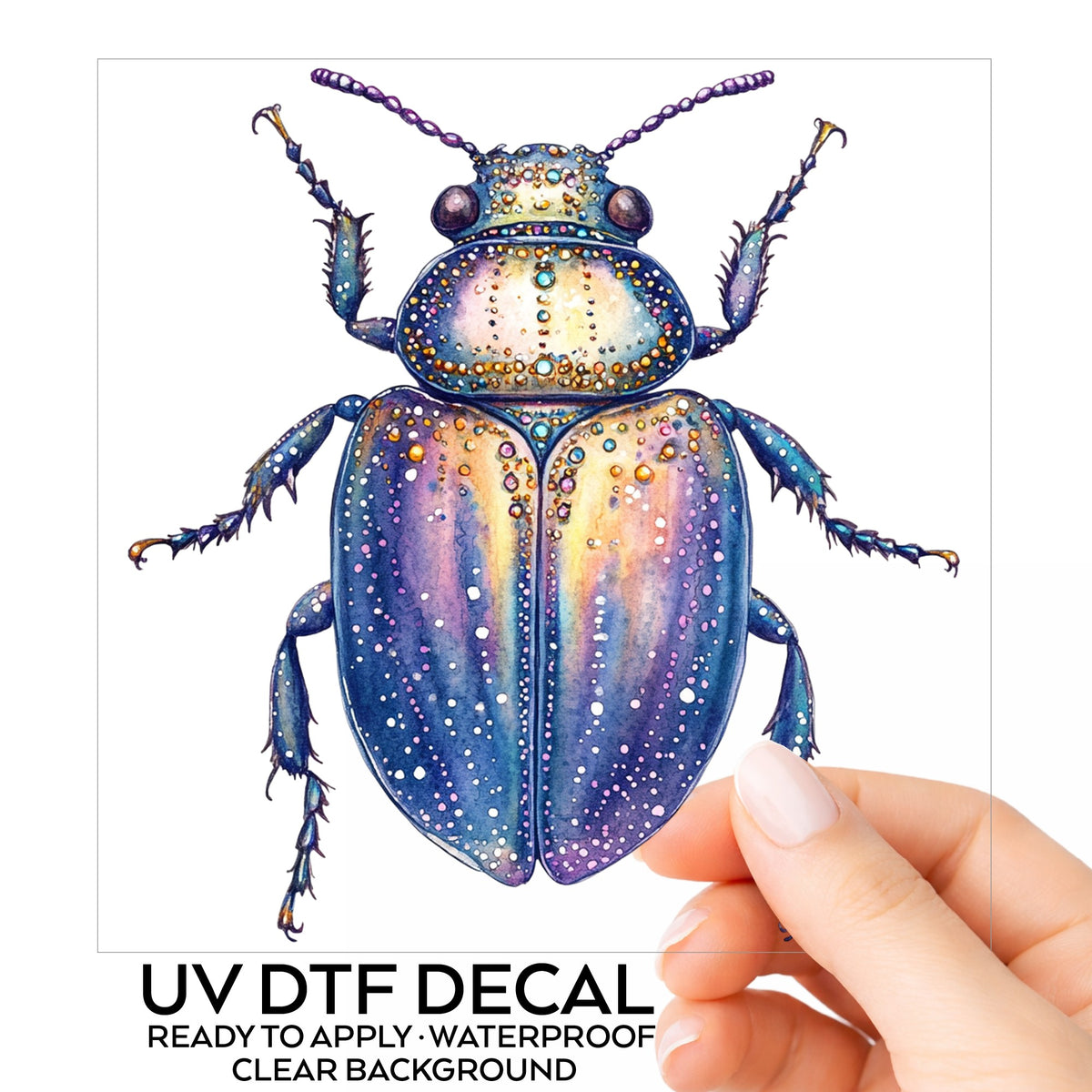 Lavender Jeweled Beetle UV DTF sticker on its backing card, held in hand