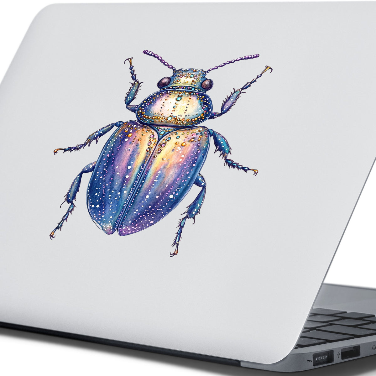 Lavender Jeweled Beetle UV DTF sticker applied to the lid of a silver laptop