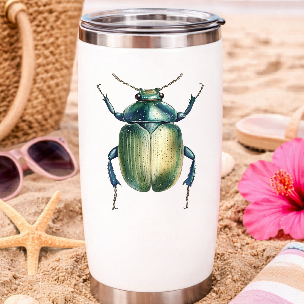 Green Scarab Beetle UV DTF sticker applied to a white travel tumbler on beach sand