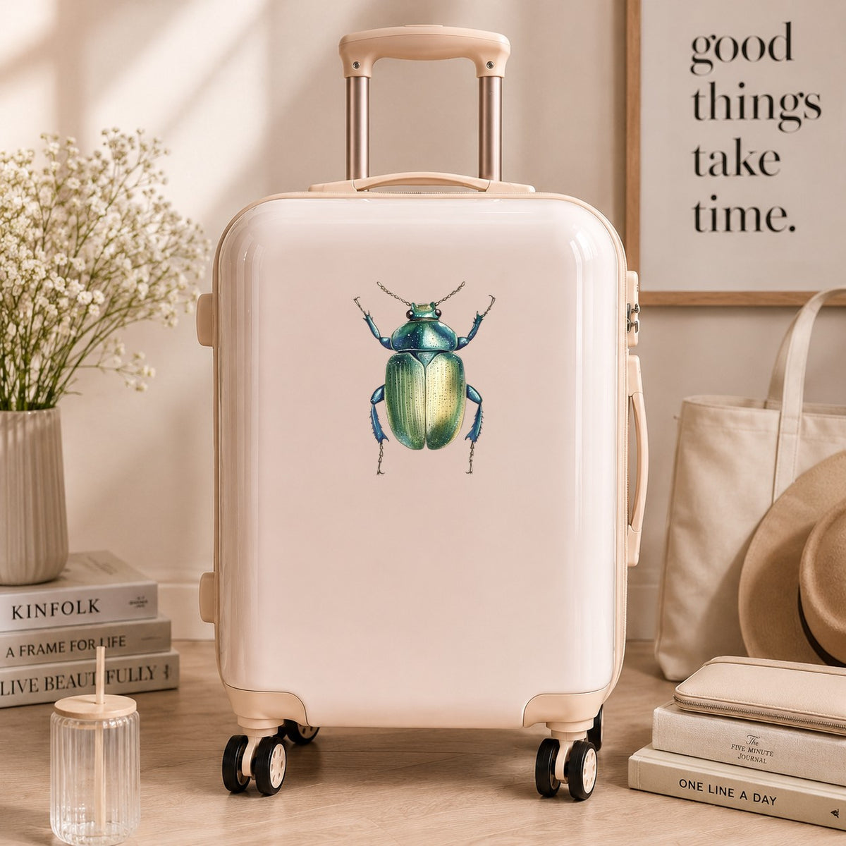 Green Scarab Beetle UV DTF sticker applied to a cream carry-on suitcase
