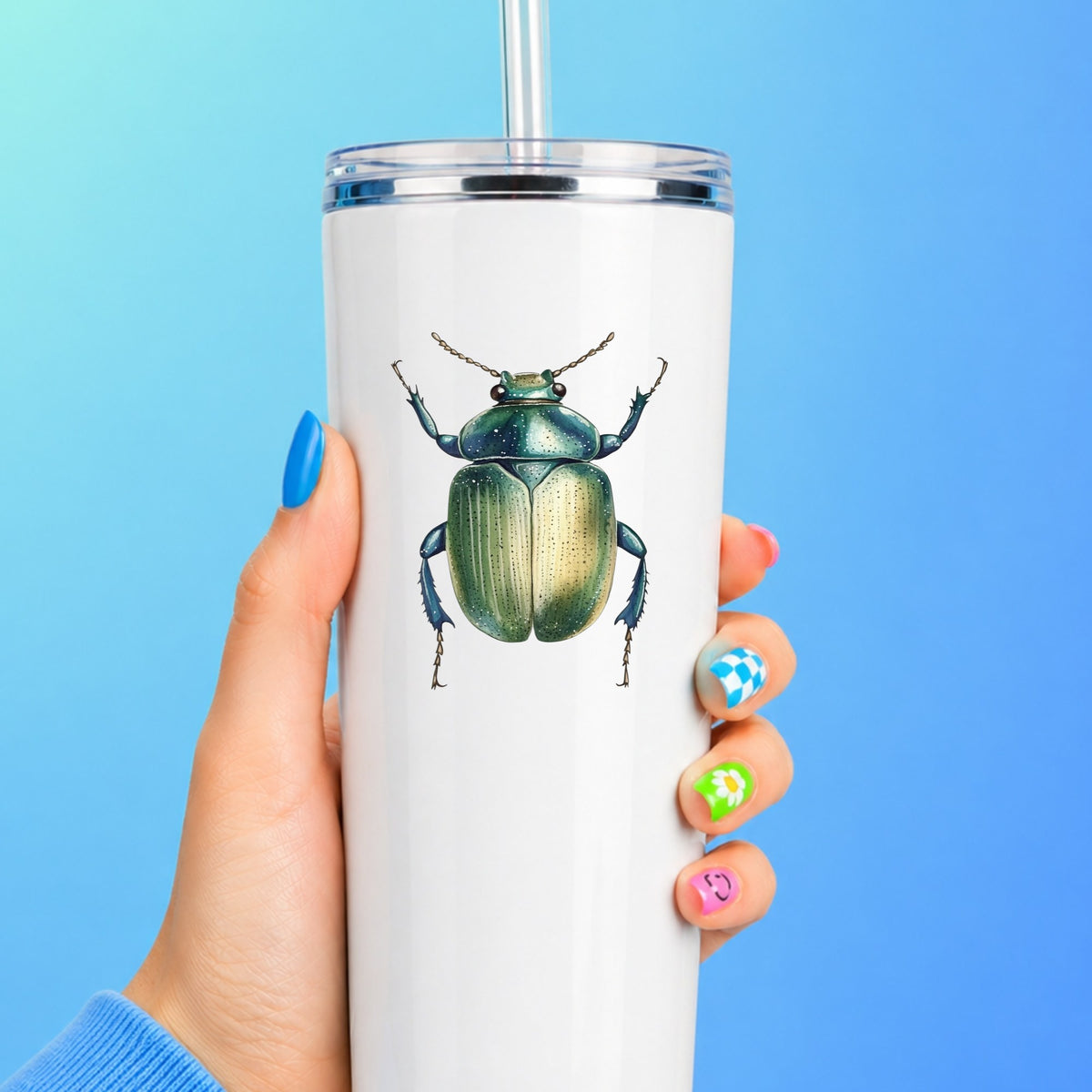 Green Scarab Beetle UV DTF sticker applied to a white straw tumbler on a blue background