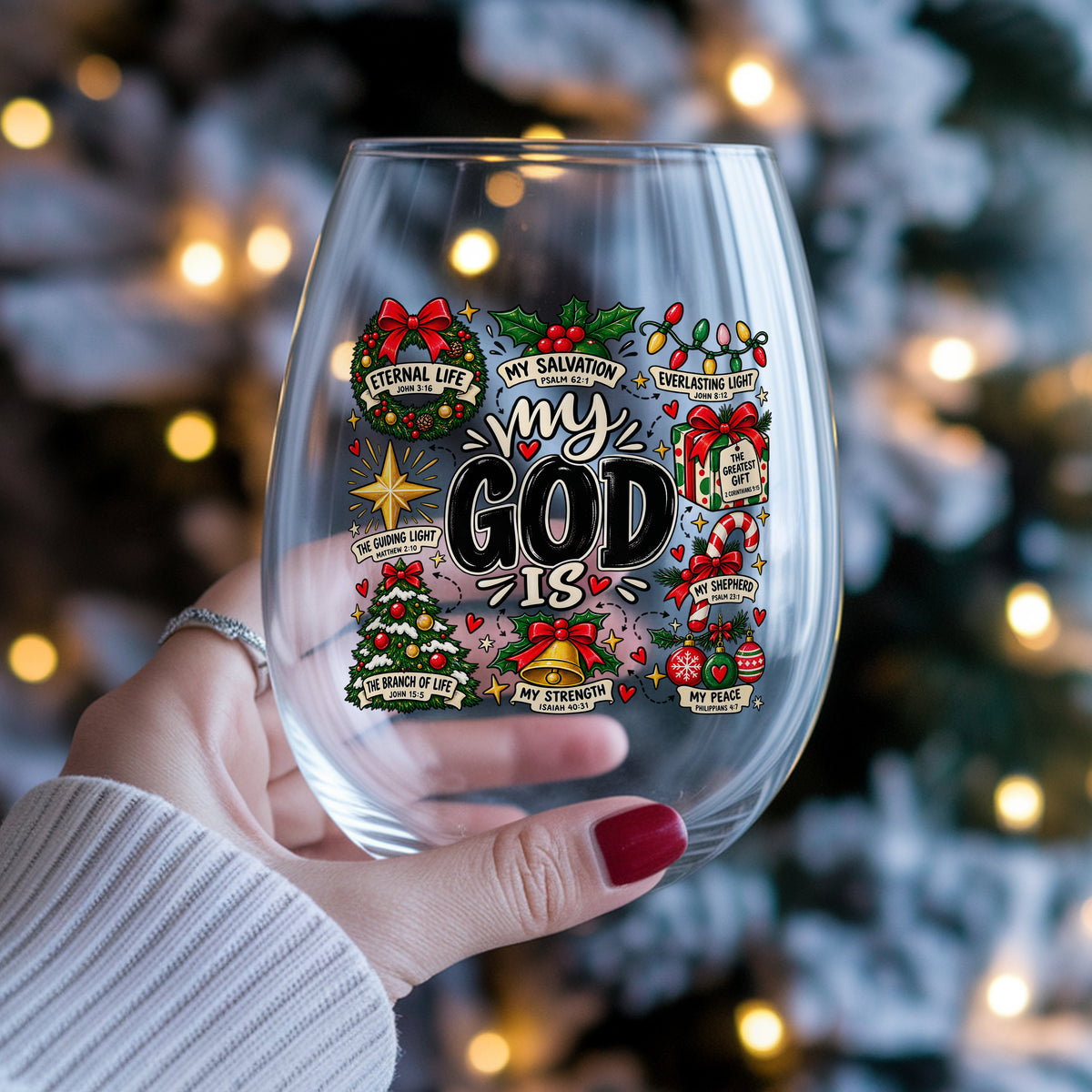 My God Is Christmas Scripture UV DTF sticker applied to a stemless wine glass held in hand