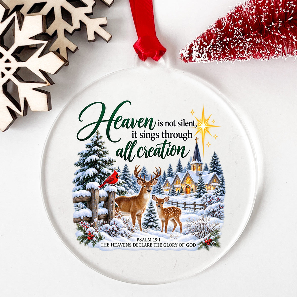 Heaven Is Not Silent Christmas Deer UV DTF sticker applied to a clear round acrylic ornament with a red ribbon