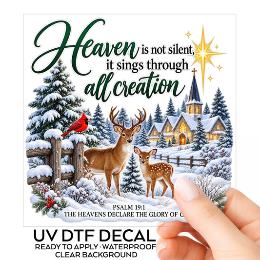 Heaven Is Not Silent Christmas Deer UV DTF sticker on its backing card, held in hand