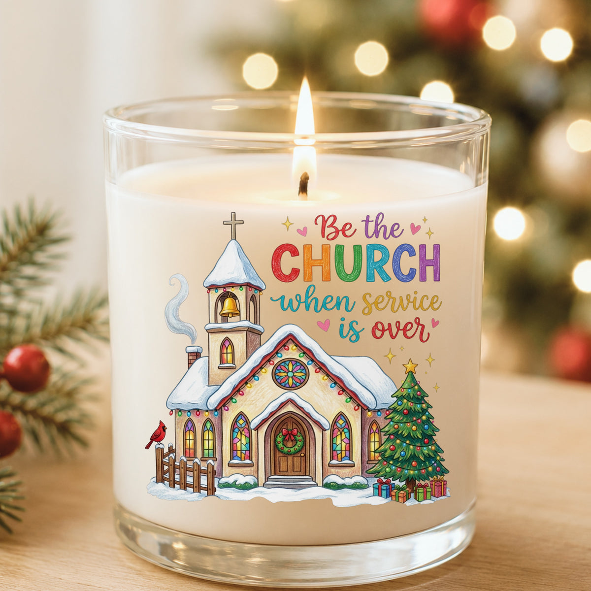 Be The Church Christmas Quote UV DTF sticker applied to a white candle in a glass holder near Christmas lights