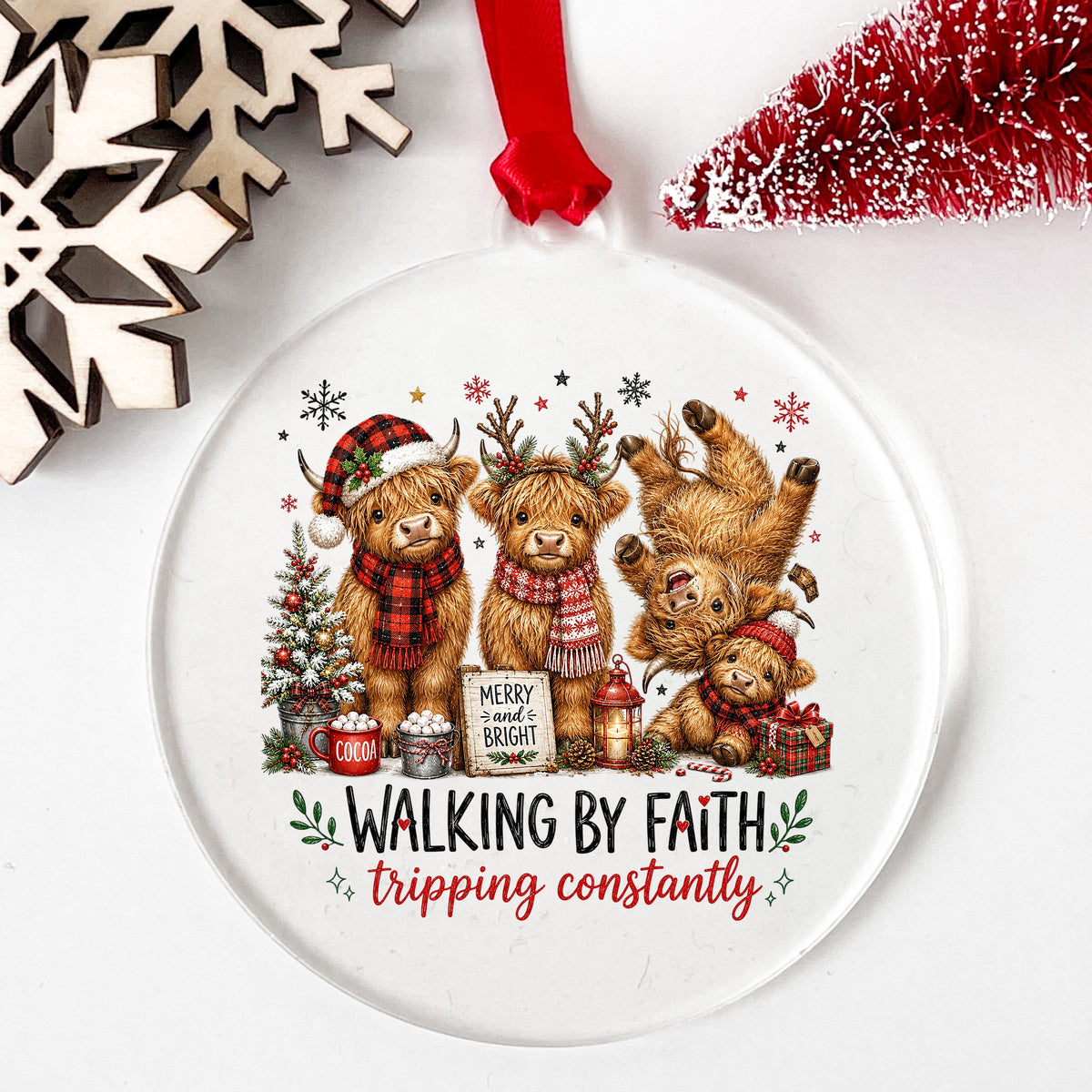 Walking By Faith Christmas Highland Cows UV DTF sticker applied to a clear round acrylic ornament with a red ribbon