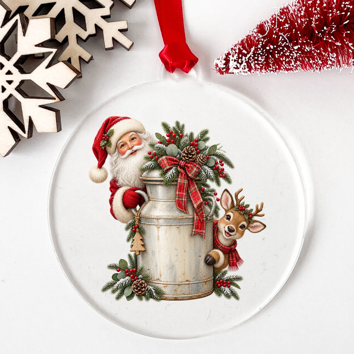 Santa And Reindeer With Milk Can UV DTF sticker applied to a clear round acrylic ornament with a red ribbon