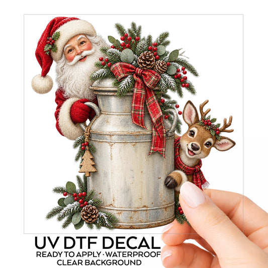 Santa And Reindeer With Milk Can UV DTF sticker on its backing card, held in hand