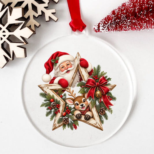 Santa And Reindeer With Wooden Star Wreath UV DTF sticker applied to a clear round acrylic ornament with a red ribbon