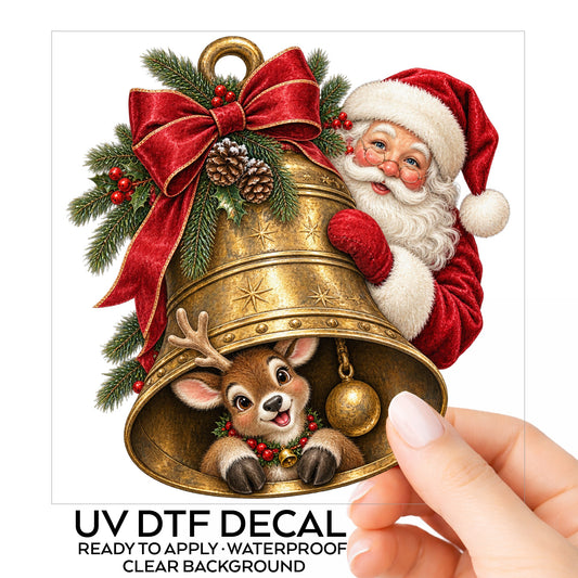 Santa And Reindeer With Gold Bell UV DTF sticker on its backing card, held in hand
