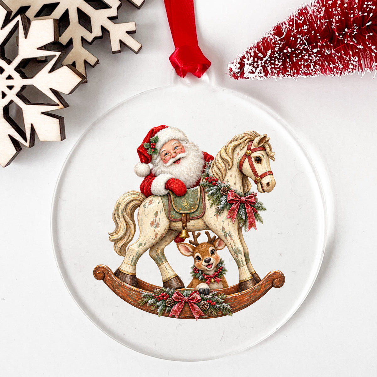 Santa Riding Rocking Horse With Reindeer UV DTF sticker applied to a clear round acrylic ornament with a red ribbon