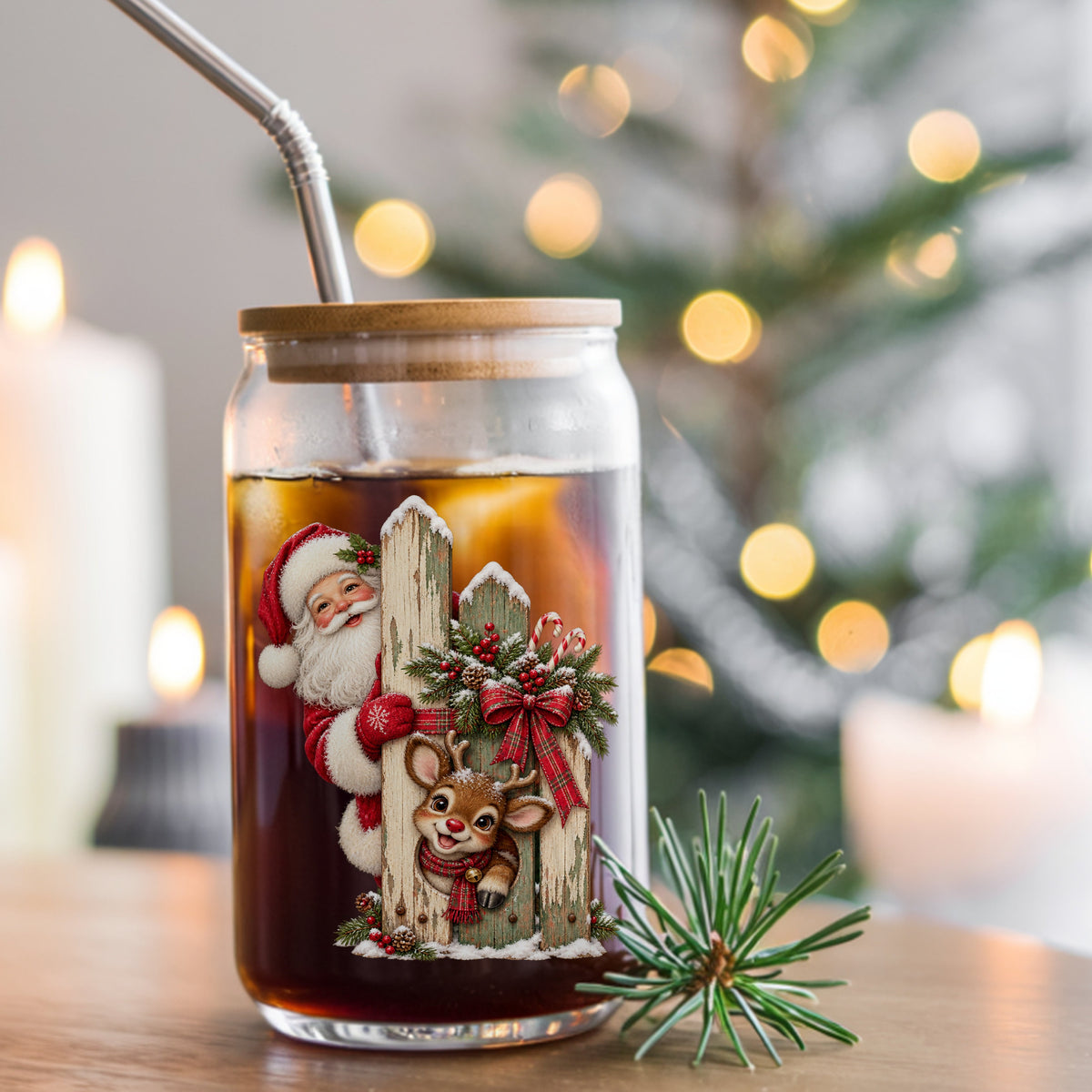 Santa And Reindeer Behind Picket Fence UV DTF sticker applied to a glass can cup of iced coffee with a straw
