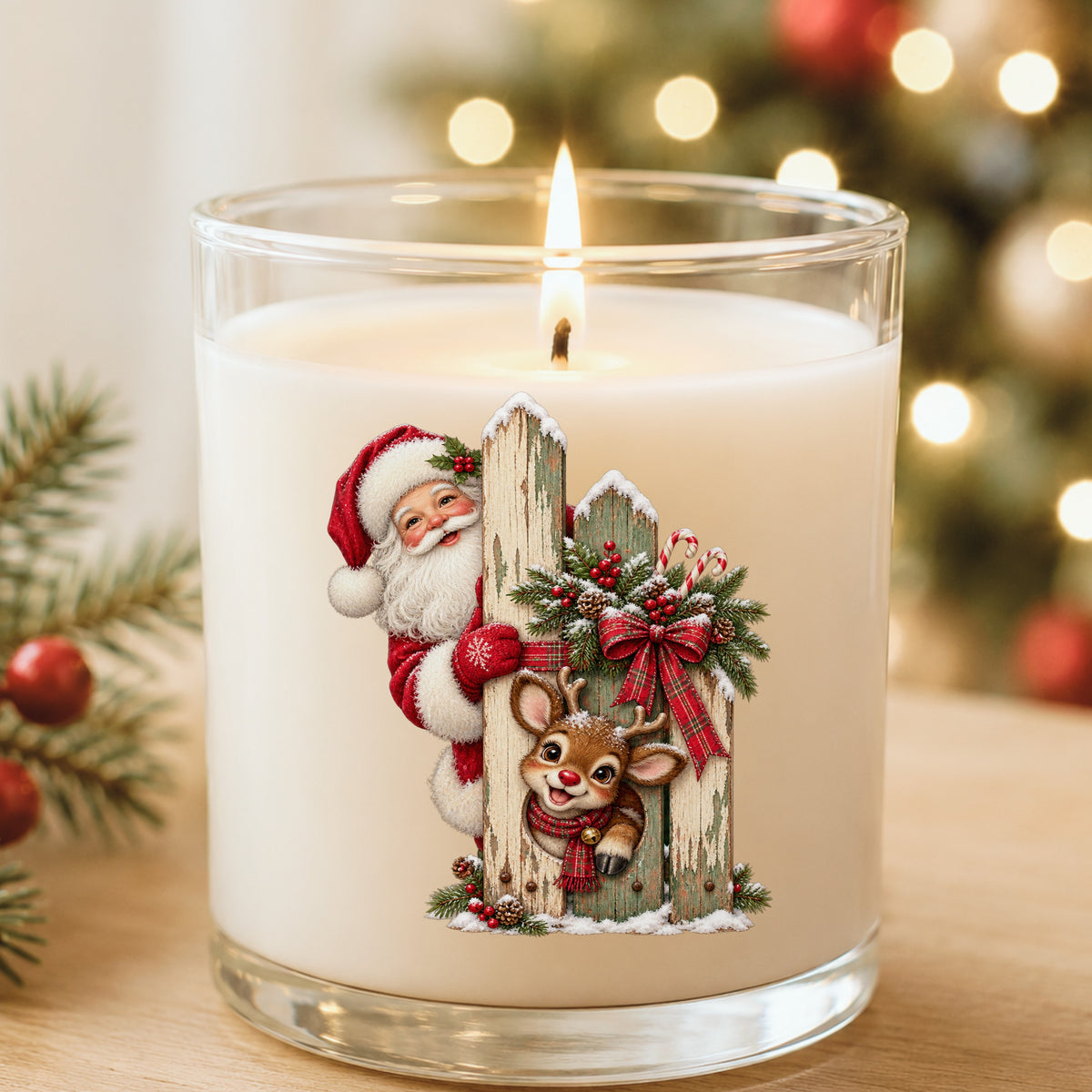 Santa And Reindeer Behind Picket Fence UV DTF sticker applied to a white candle in a glass holder near Christmas lights