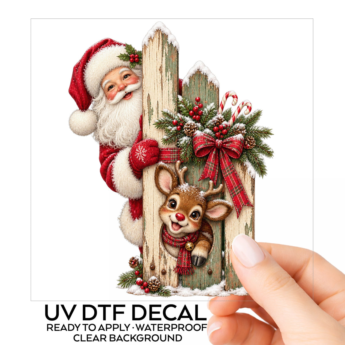 Santa And Reindeer Behind Picket Fence UV DTF sticker on its backing card, held in hand