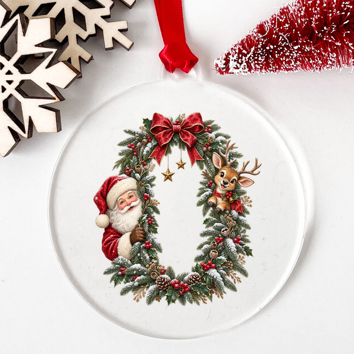 Santa And Reindeer Peeking Through Christmas Wreath UV DTF sticker applied to a clear round acrylic ornament with a red ribbon