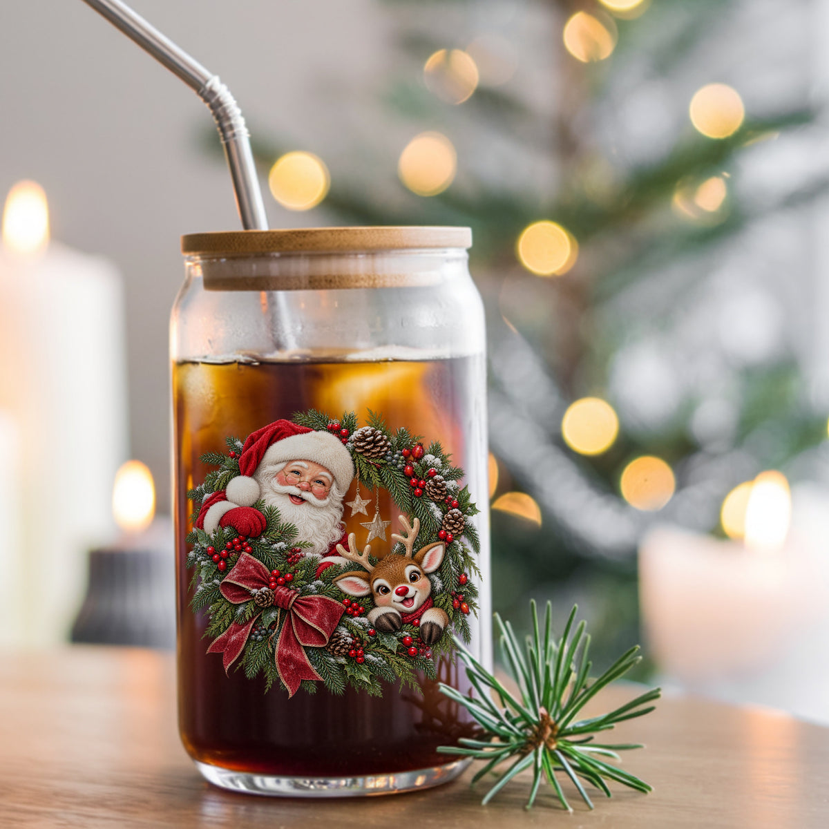 Santa And Reindeer In Berry Pinecone Wreath UV DTF sticker applied to a glass can cup of iced coffee with a straw