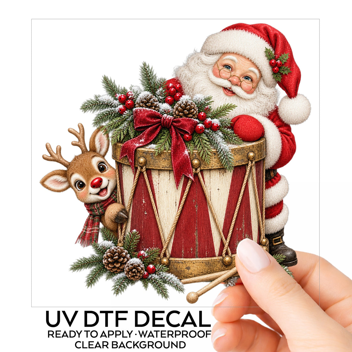 Santa And Reindeer With Vintage Toy Drum UV DTF sticker on its backing card, held in hand