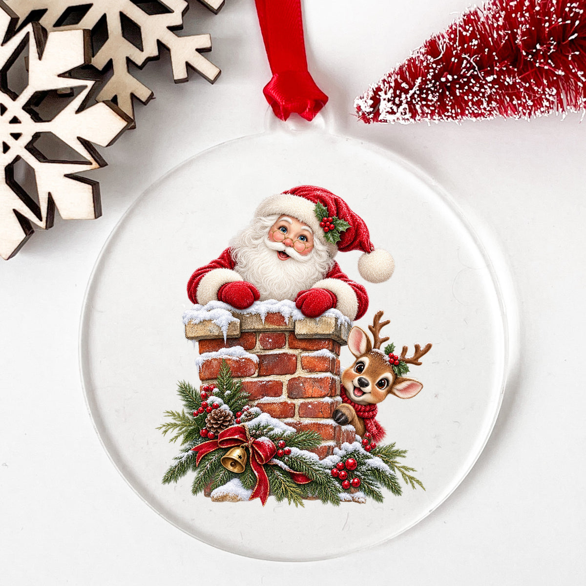 Santa And Reindeer At Brick Chimney UV DTF sticker applied to a clear round acrylic ornament with a red ribbon