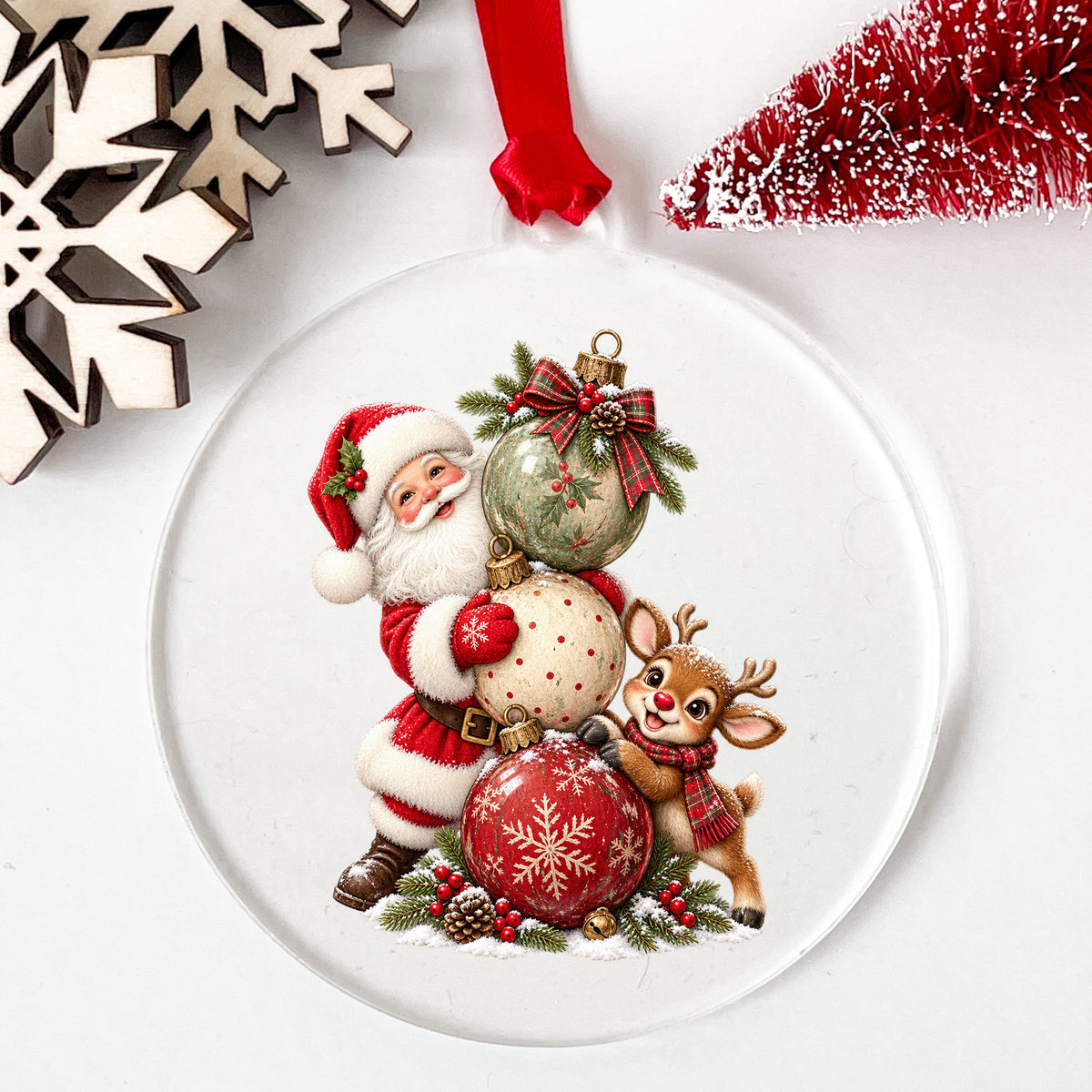 Santa And Reindeer With Stacked Ornaments UV DTF sticker applied to a clear round acrylic ornament with a red ribbon