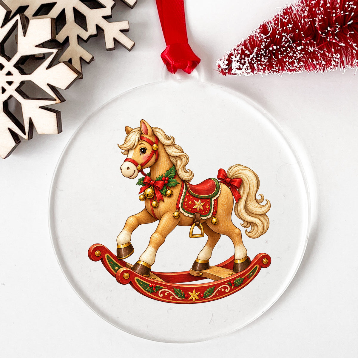 Vintage Christmas Rocking Horse UV DTF sticker applied to a clear round acrylic ornament with a red ribbon
