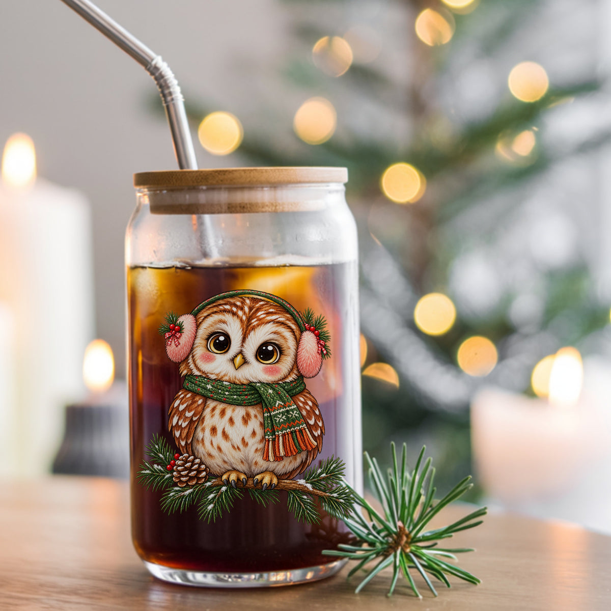 Owl With Earmuffs And Scarf On Pine Branch UV DTF sticker applied to a glass can cup of iced coffee with a straw
